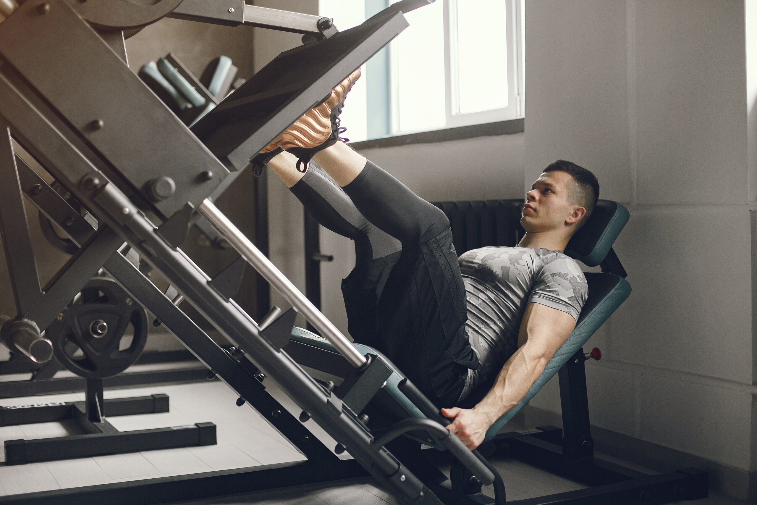 Man performing leg press exercise as part of leg day workout routine to strengthen lower body