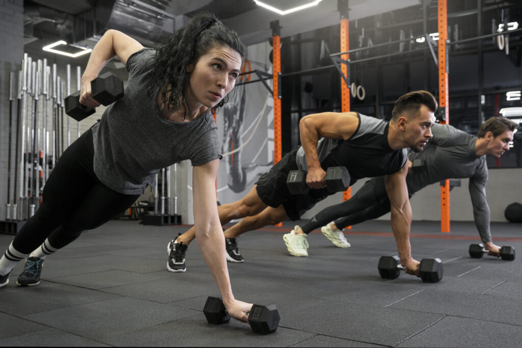 Person performing structured workout sets with dumbbells in a gym